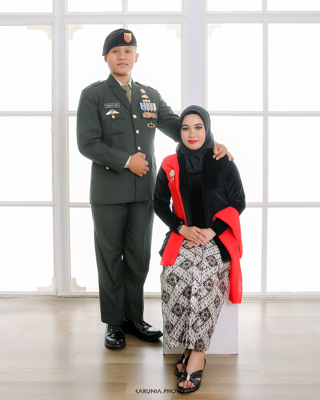 Bride and groom-to-be holding hands and walking along city streets with romantic bokeh lights